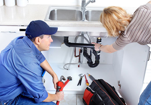 Plumber explaining an under-sink repair