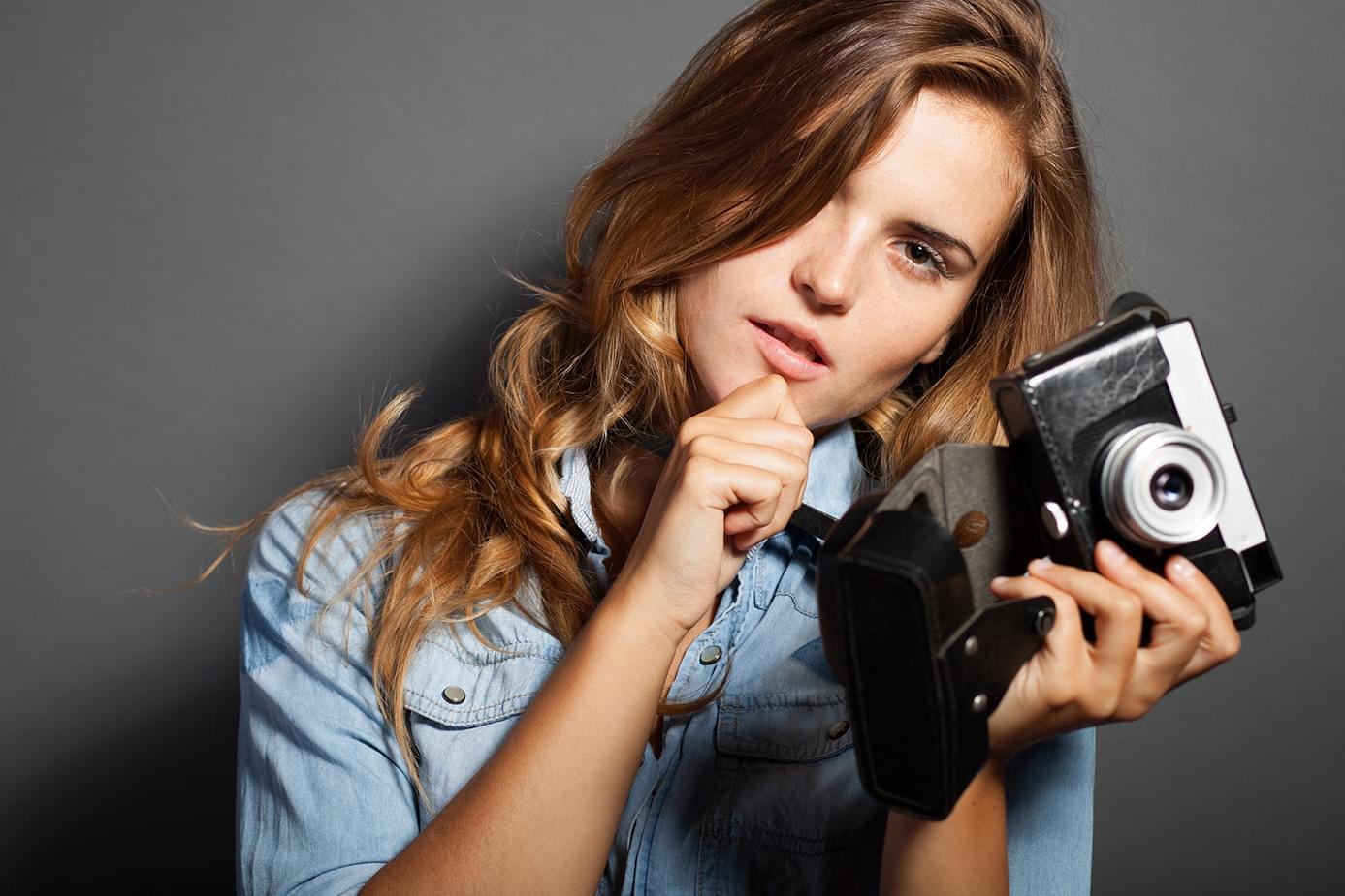 Photographer holding a vintage camera
