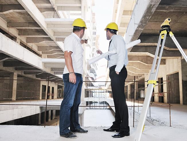 Project manager reviewing plans on site